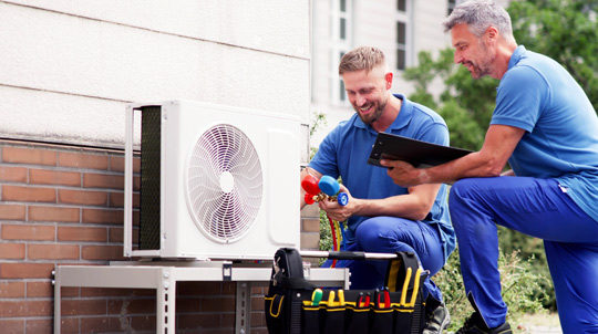 Technician working on heat pump